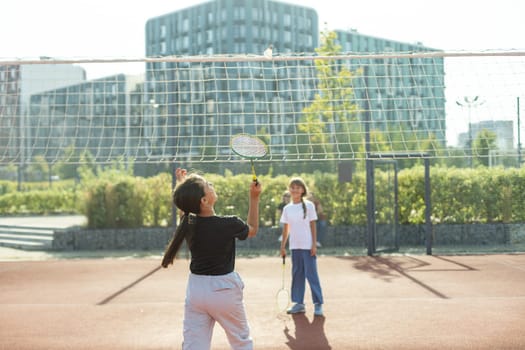Two girls with badminton rackets on the football field. High quality photo