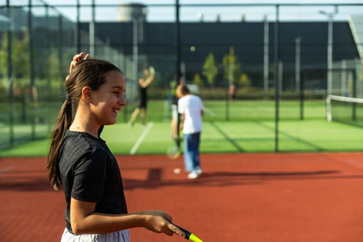 Two girls with badminton rackets on the football field. High quality photo