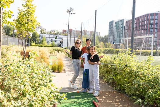 golfers with parents playing golf at sunny day. High quality photo