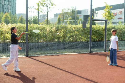 Two girls with badminton rackets on the football field. High quality photo
