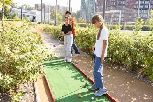 family playing mini golf on a cruise liner. Child having fun with active leisure on vacations. High quality photo