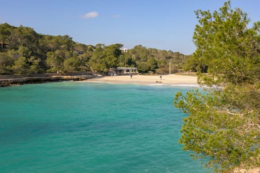 Tranquil beach with crystal clear turquoise waters and lush surroundings, cala mondrago, mallorca, balearic island, spain,