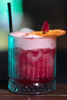 A beautiful bright cocktail. Restaurant, a glass with a drink is on the table.