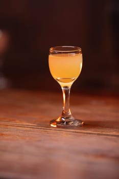 A beautiful bright cocktail. Restaurant, a glass with a drink is on the table.