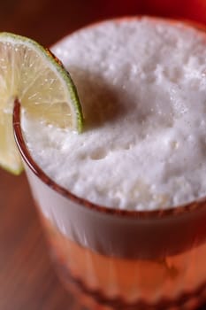 A beautiful bright cocktail. Restaurant, a glass with a drink is on the table.