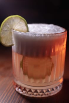 A beautiful bright cocktail. Restaurant, a glass with a drink is on the table.