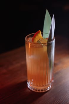 A beautiful bright cocktail. Restaurant, a glass with a drink is on the table.