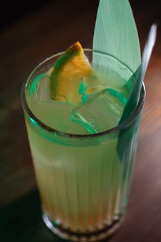 A beautiful bright cocktail. Restaurant, a glass with a drink is on the table.