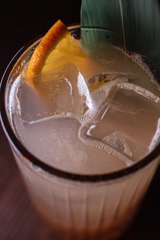 A beautiful bright cocktail. Restaurant, a glass with a drink is on the table.