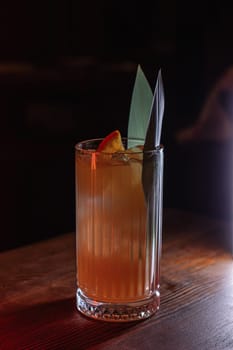 A beautiful bright cocktail. Restaurant, a glass with a drink is on the table.