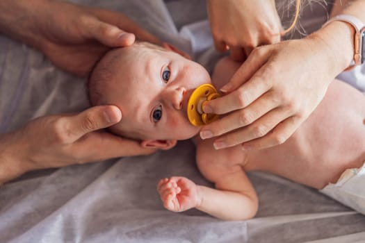 A newborn baby receives gentle osteopathic care, lying calmly while the specialist carefully examines and adjusts the infant. A moment of professional pediatric care, early development, and holistic well-being, symbolizing health and nurturing touch.