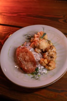 Baked turkey and cauliflower are a delicious dish on the menu at the restaurant. A beautiful and delicious photo for a menu, culinary website, or an advertisement for catering establishments.