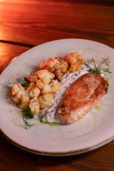 Baked turkey and cauliflower are a delicious dish on the menu at the restaurant. A beautiful and delicious photo for a menu, culinary website, or an advertisement for catering establishments.