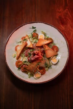 Caesar salad with bacon is mouthwatering and delicious. A beautiful perfect photo for a cafe or restaurant menu, advertisement, culinary website. Suitable for design.