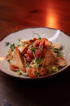 Caesar salad with bacon is mouthwatering and delicious. A beautiful perfect photo for a cafe or restaurant menu, advertisement, culinary website. Suitable for design.