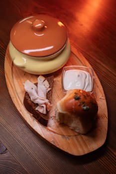 Restaurant dish borscht, delicious bread with bacon, sour cream, bun. A delicious photo for a menu, culinary website, or an advertisement for catering establishments