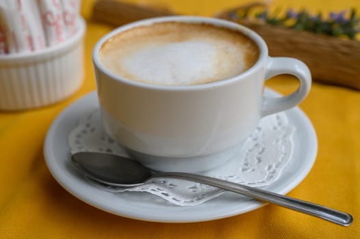 Sipping warm coffee in a cozy cafe, surrounded by cheerful colors—perfect for a relaxing moment.