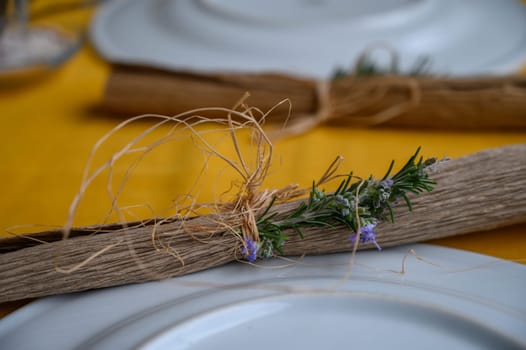 Delicate greenery and rustic twine create a charming atmosphere for a special meal, inviting warmth and comfort.
