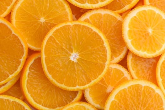 Overlapping juicy orange slices create a sunny, cheerful scene that invites freshness.