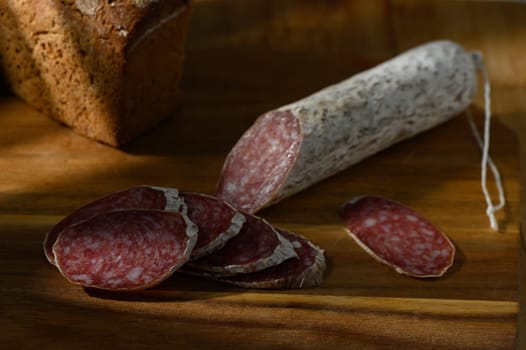 Delicious salami slices with rustic bread create a warm, inviting atmosphere perfect for a delightful meal.
