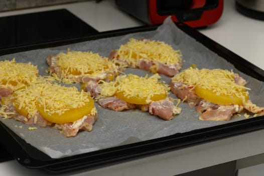Tender chicken thighs are layered with pineapple slices and shredded cheese, ready to bake for a delicious meal.