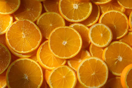 Freshly cut orange slices radiate warmth and color, inviting a sense of joy and health into a sunny kitchen.