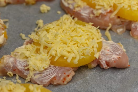 Slices of chicken are layered with sweet pineapple and cheese, ready for a delicious bake in the oven.