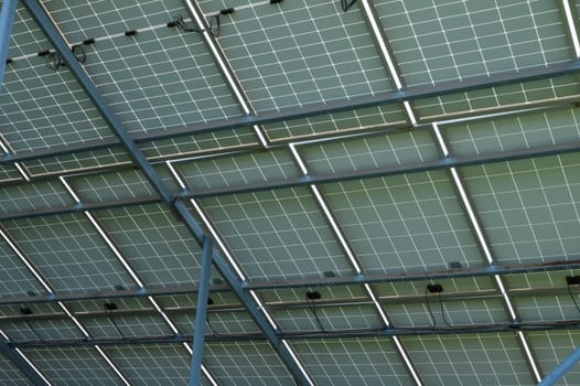 Energy-efficient solar panels capture sunlight, showcasing green technology on a contemporary structure's roof.