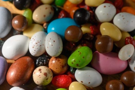 Vibrant candies of various shapes and colors delight the senses on a rustic wooden setting, ready to be enjoyed.