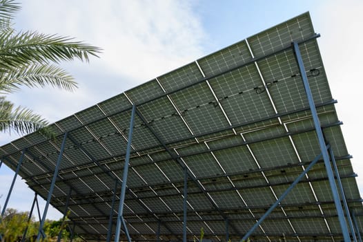 Solar panels stand tall against the sky, showcasing sustainable energy solutions in a lush, green environment.