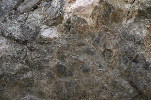 Intricate patterns and shades dance across the weathered rock, showcasing nature's artistic mastery and rich textures.