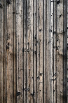 Beautifully aged wooden planks reveal intricate textures and shades, reflecting years of natural exposure and charm.