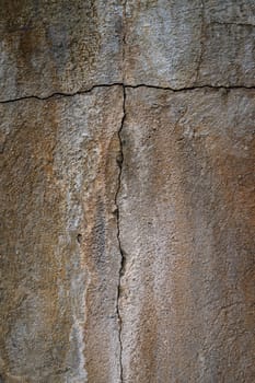 Surface displays jagged cracks and worn textures, telling a story of time and natural elements affecting its appearance.