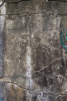 Texture of a cracked stone wall covered with vibrant graffiti, reflecting artistic expression and urban decay.