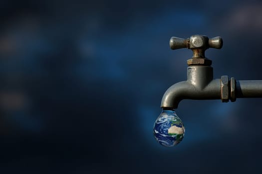 A captivating image of Earth inside a water droplet hanging from a faucet, symbolizing the need for water conservation and environmental awareness.