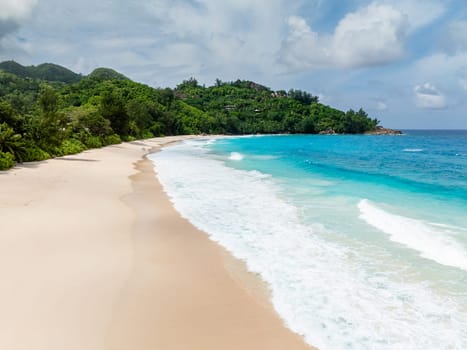 Golden sands meet turquoise waves on this idyllic beach. Seychelles. Anse Intendance beach.