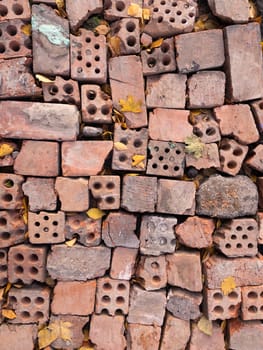 Red old broken bricks with holes texture background