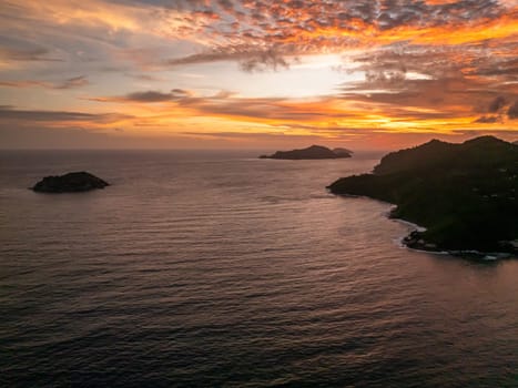 Tropical islands during a colorful sunset over the ocean. Seychelles, Mahe.