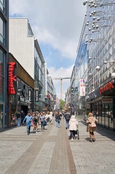 Cologne, Germany – May 19, 2024: People in Hohe Strasse, a popular shopping street in Cologne, Germany