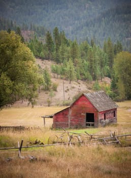 An old red barn in the middle of an open pasture east of Coeur d'Alene, Idaho.