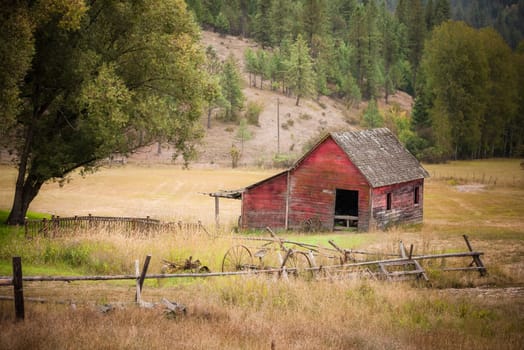 An old red barn in the middle of an open pasture east of Coeur d'Alene, Idaho.