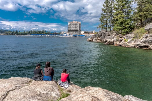 A mother and her two kids enjoying the view of Coeur d'Alene lake and the resort from Tubbs Hill.