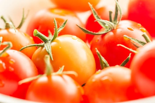 A close up image of ripe cherry tomatoes in bright light.
