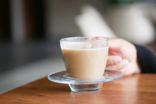 Enjoying warm coffee served in a beautiful glass cup with a calming ambiance