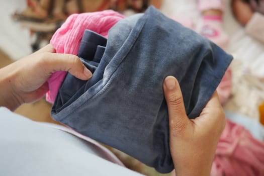 Person is folding laundry in a warm and inviting living space.