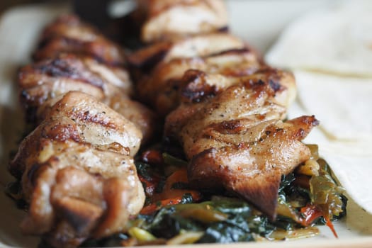 Savory grilled chicken skewers served with fresh vegetables ready to enjoy.