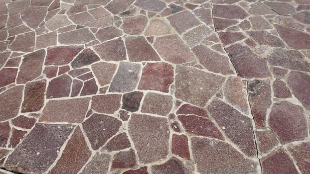 A detailed view of a stone pathway featuring rich textures and colors.