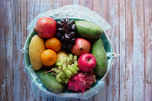 A colorful assortment of fresh fruits is arranged in a basket.