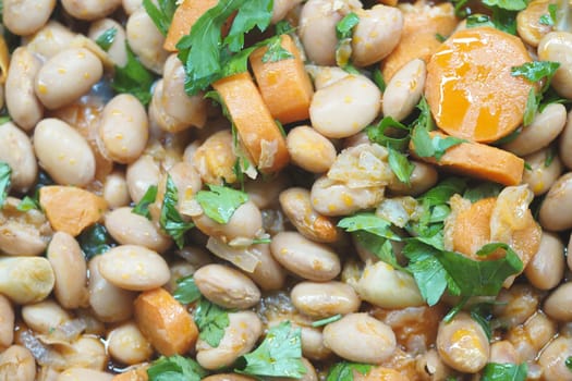 A tasty mix of white beans, carrots, and fresh herbs cooked together.