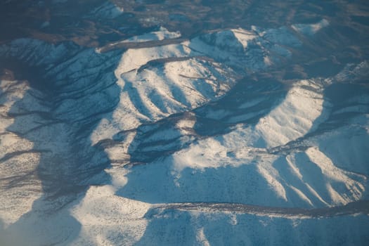 Vast snow-covered mountains stretch under clear skies, captivating any observer.